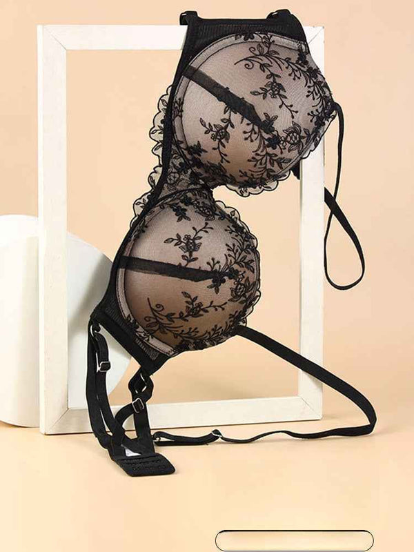 Black SKIMS Kardashian Gathering Lingerie sheer lace bra with floral embroidery and adjustable straps.