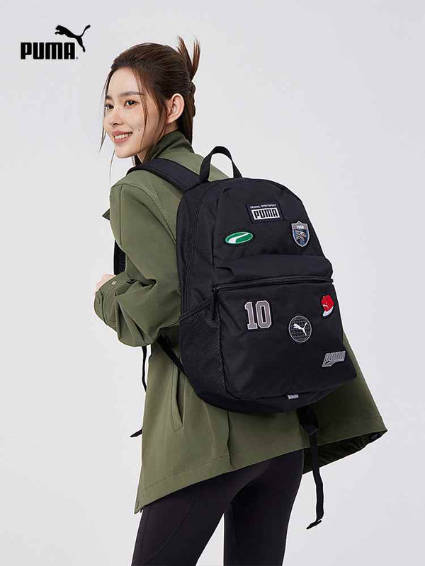 Black PUMA practical and stylish backpack with multiple patches worn by a smiling woman