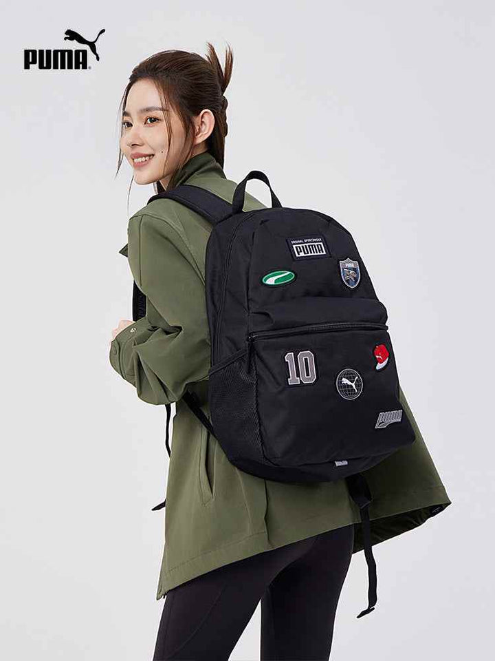 Black PUMA practical and stylish backpack with multiple patches worn by a smiling woman