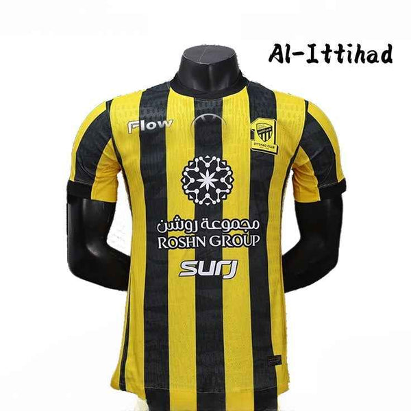 Yellow and black striped Al-Ittihad football club home jersey 2025/26 season with breathable fabric and sponsor logos.