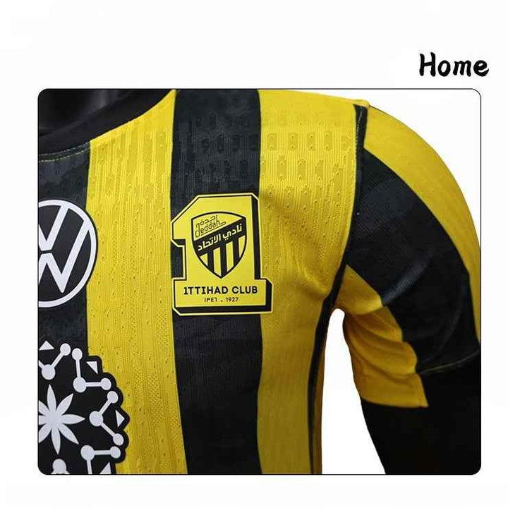 Close-up of Ittihad Club 2025/26 home jersey with yellow and black vertical stripes and club logo on chest.