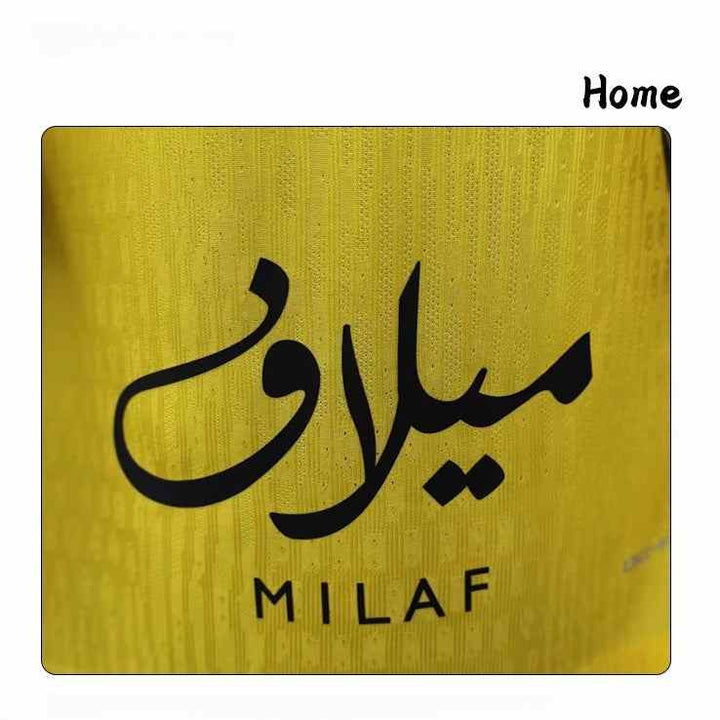 Milaf logo detail on yellow breathable fabric of Al Ittihad Club 2025/26 home jersey with black vertical stripes.