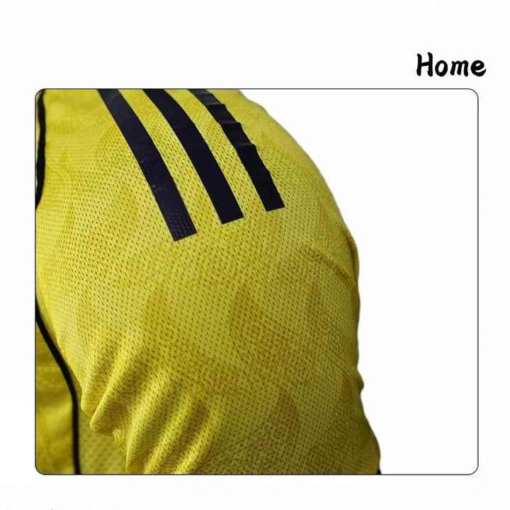 Close-up of yellow Nassr Riyadh 1955 football jersey sleeve with black stripes and breathable fabric design.