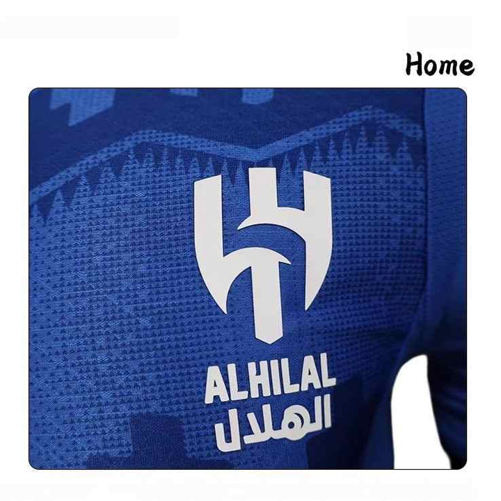 Close-up of Al Hilal football club's official 2025/26 blue home jersey with geometric heritage-inspired patterns and club logo in white.