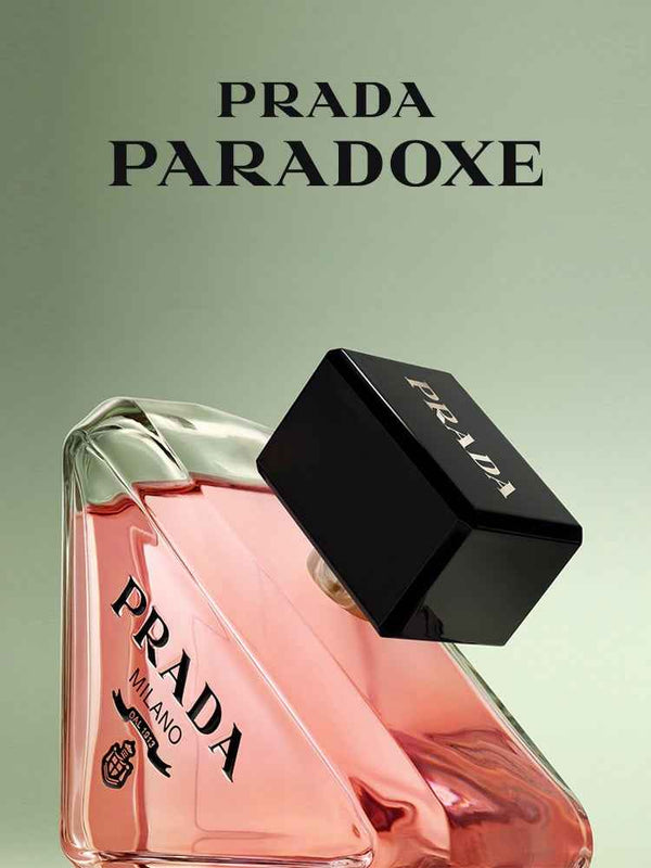 PRADA Paradoxe women's luxury perfume with elegant pink bottle and black cap against light green background