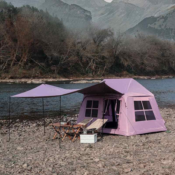 Wolf Walker Cloud Pavilion Inflatable Tent camping tent with large canopy set up by a river in a rocky outdoor area.
