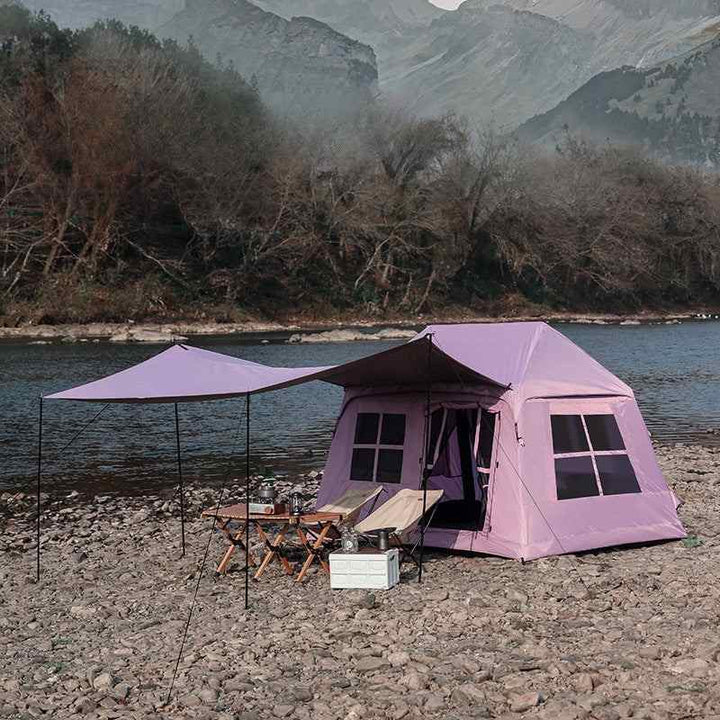Wolf Walker Cloud Pavilion Inflatable Tent camping tent with large canopy set up by a river in a rocky outdoor area.