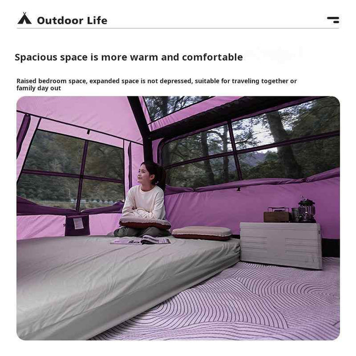 Interior view of Wolf Walker Cloud Pavilion inflatable tent showing spacious and comfortable raised bedroom space with woman seated inside during outdoor camping